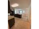 Kitchen with island, dark cabinets, and view into the living room at 5716 Lakeside Landings Blvd, Winter Haven, FL 33881