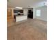 Open kitchen layout with island, dark cabinets, and living room view at 5716 Lakeside Landings Blvd, Winter Haven, FL 33881