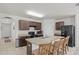 Spacious kitchen with an island, dark cabinets, and stainless steel appliances at 5716 Lakeside Landings Blvd, Winter Haven, FL 33881