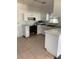 Kitchen with white cabinets and tiled floor needing renovation at 207 Robin Rd, Altamonte Springs, FL 32701