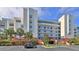 Exterior view of a multi-story building with parking and landscaping at 5300 S Atlantic Ave # 16-602, New Smyrna Beach, FL 32169