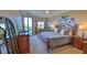 Main bedroom with king bed, private balcony access, and lots of natural light at 5300 S Atlantic Ave # 16-602, New Smyrna Beach, FL 32169