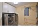 Modern laundry room featuring a washer, dryer, and cabinets at 5300 S Atlantic Ave # 16-602, New Smyrna Beach, FL 32169
