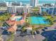 Aerial view of community pool and tennis courts with parking at 5300 S Atlantic Ave # 16-602, New Smyrna Beach, FL 32169