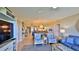 Open living space with comfortable seating and a large TV at 5300 S Atlantic Ave # 16-602, New Smyrna Beach, FL 32169