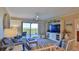 Living room with large TV, balcony access, and relaxing seating at 5300 S Atlantic Ave # 16-602, New Smyrna Beach, FL 32169