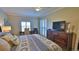 Bright bedroom featuring a king bed, dresser, and workspace at 5300 S Atlantic Ave # 16-602, New Smyrna Beach, FL 32169