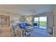 Bright living room with comfy seating, large windows and access to balcony at 5300 S Atlantic Ave # 16-602, New Smyrna Beach, FL 32169