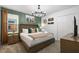 Cozy bedroom featuring a king-size bed and rustic decor at 9106 Sommerset Hills Dr, Davenport, FL 33896