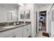 Double vanity bathroom with gray counters and access to a playroom at 9106 Sommerset Hills Dr, Davenport, FL 33896