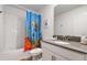 Bathroom with a tub, toilet, and under-the-sea themed shower curtain at 9106 Sommerset Hills Dr, Davenport, FL 33896