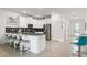 Open kitchen boasting white cabinets and breakfast bar with teal stools at 9106 Sommerset Hills Dr, Davenport, FL 33896