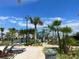 Relaxing pool deck area with lounge chairs and palm trees at 9106 Sommerset Hills Dr, Davenport, FL 33896