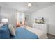 King-size bed, modern dresser, and TV in a bright bedroom at 9106 Sommerset Hills Dr, Davenport, FL 33896