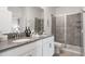 Modern bathroom with double vanity, gray counters, and a large walk-in shower at 9106 Sommerset Hills Dr, Davenport, FL 33896