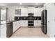 Modern kitchen with white cabinets, stainless steel appliances, and a breakfast bar at 9106 Sommerset Hills Dr, Davenport, FL 33896