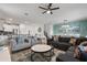 Spacious living room with comfy sofas, large windows, and a ceiling fan at 9106 Sommerset Hills Dr, Davenport, FL 33896