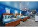 Two twin beds in a themed bedroom with ocean mural and unique lighting at 9106 Sommerset Hills Dr, Davenport, FL 33896