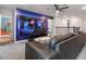 Game room boasting a large TV, sectional sofa, and space-themed wall art at 9106 Sommerset Hills Dr, Davenport, FL 33896