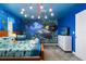 Under the sea themed bedroom with twin beds, ocean mural and dresser at 9106 Sommerset Hills Dr, Davenport, FL 33896