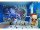 Twin bedroom with ocean-themed mural, and two twin beds at 9106 Sommerset Hills Dr, Davenport, FL 33896