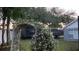 Backyard with a wooden arbor and adjacent building at 1046 Shinnecock Hills Dr, Oviedo, FL 32765