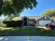 Gray house with a brick facade, landscaped yard, and two-car garage at 1046 Shinnecock Hills Dr, Oviedo, FL 32765