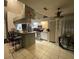 Open concept kitchen with breakfast bar and view into dining area at 1046 Shinnecock Hills Dr, Oviedo, FL 32765