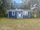 Blue house exterior with white trim and green lawn at 2204 Ernest St, Kissimmee, FL 34741