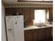 Kitchen with wood cabinets, a double sink, and a refrigerator at 2681 Washington Ave # 18, Eustis, FL 32726