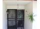 Inviting front entrance with security gate and mature plant at 2681 Washington Ave # 18, Eustis, FL 32726