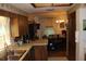 Kitchen with wood cabinets, double sink, and a view into the dining area at 2681 Washington Ave # 18, Eustis, FL 32726