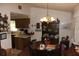 A round wooden dining table with chairs, hutch, and kitchen view at 2681 Washington Ave # 18, Eustis, FL 32726
