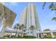 High-rise building exterior with palm trees and entrance at 231 Riverside Drive # 101-1, Holly Hill, FL 32117