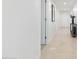 Bright hallway with light tile floors and neutral walls at 231 Riverside Drive # 101-1, Holly Hill, FL 32117