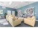 Spacious community room with seating area and extensive book collection at 231 Riverside Drive # 101-1, Holly Hill, FL 32117