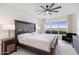 Main bedroom with large windows and an ornate headboard at 231 Riverside Drive # 101-1, Holly Hill, FL 32117