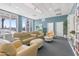 Relaxing community room with comfortable seating, bookshelves, and large windows at 231 Riverside Drive # 101-1, Holly Hill, FL 32117