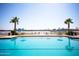 Inviting community pool with waterfront views and lounge chairs at 231 Riverside Drive # 101-1, Holly Hill, FL 32117