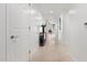 Bright hallway with tile floors and a console table at 231 Riverside Drive # 101-1, Holly Hill, FL 32117