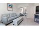 Comfortable living room featuring a gray sofa and ottoman at 231 Riverside Drive # 101-1, Holly Hill, FL 32117
