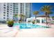 Sparkling blue pool surrounded by palm trees at 231 Riverside Drive # 101-1, Holly Hill, FL 32117
