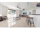 Open living area with modern coffee table and two barstools at 231 Riverside Drive # 101-1, Holly Hill, FL 32117