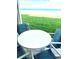 Small patio table and chairs overlooking the ocean at 4175 S Atlantic Ave # 1020, New Smyrna Beach, FL 32169