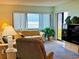 Living room with ocean view and comfy furniture at 4175 S Atlantic Ave # 1020, New Smyrna Beach, FL 32169