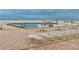 Community pool with lounge chairs and ocean views at 4175 S Atlantic Ave # 1020, New Smyrna Beach, FL 32169