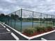 Newly resurfaced tennis court with green fencing at 4175 S Atlantic Ave # 1020, New Smyrna Beach, FL 32169