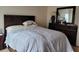 Bedroom with a double bed, dresser, and patterned bedding at 332 David Walker Dr # J-2, Tavares, FL 32778