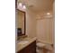 Bathroom with granite vanity, shower/tub combo, and a beige curtain at 332 David Walker Dr # J-2, Tavares, FL 32778