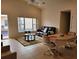Spacious living room with tile floors, brown leather couch, and dining area at 332 David Walker Dr # J-2, Tavares, FL 32778